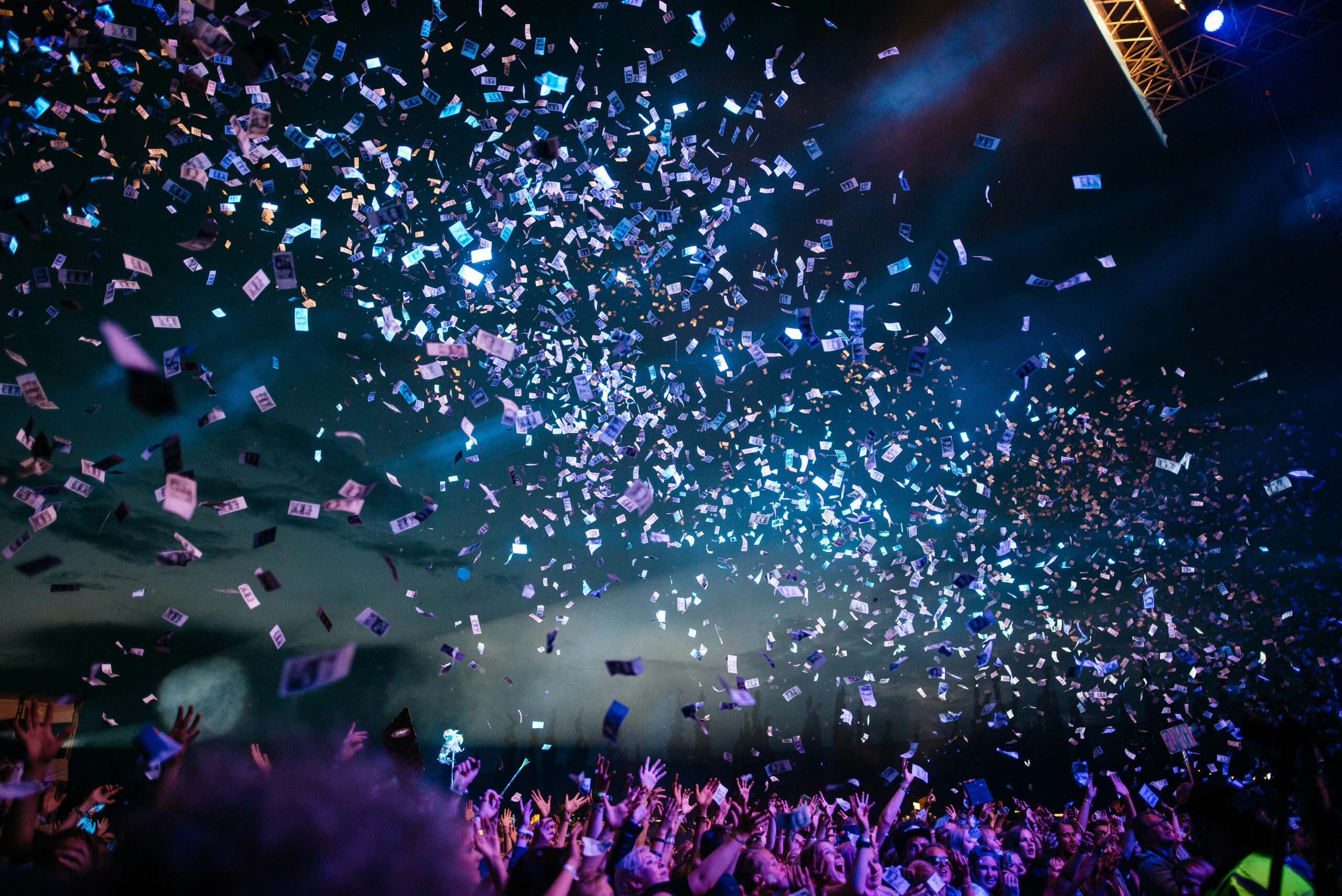 Confetti over a crowd at an internal concert event as part of a celebration